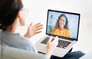 woman is using laptop for remote conversation